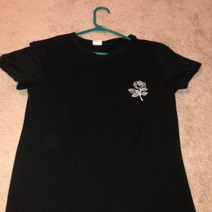 Black shirt with a rose on left side